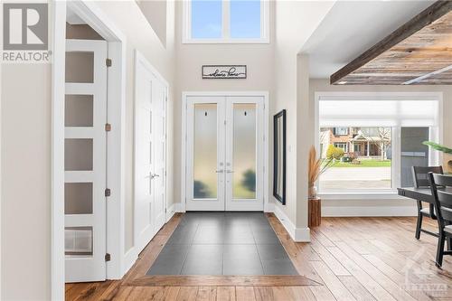 Greeted by stunning cathedral ceilings, the entrance of this home is bathed in natural light. A classic tiled entryway transitions to hardwood flooring, while a double closet offers practical stor - 52 Moore Street, Ottawa, ON - Indoor Photo Showing Other Room