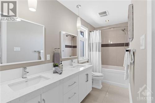 5 piece family bathroom with double granite sinks, and bathtub/shower combo. - 52 Moore Street, Ottawa, ON - Indoor Photo Showing Bathroom