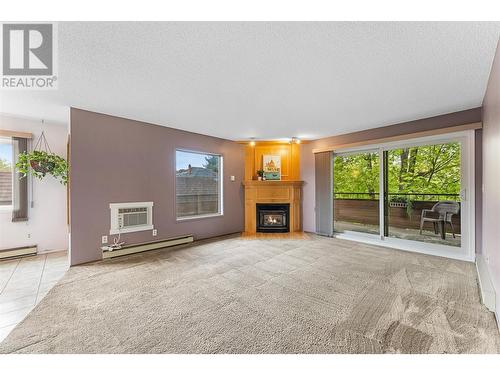 983 Bernard Avenue Unit# 208, Kelowna, BC - Indoor Photo Showing Living Room With Fireplace