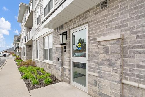 Entry door to units is at back of building - conveniently located near parking area. - 67 Haddington Street|Unit #304, Caledonia, ON - Outdoor