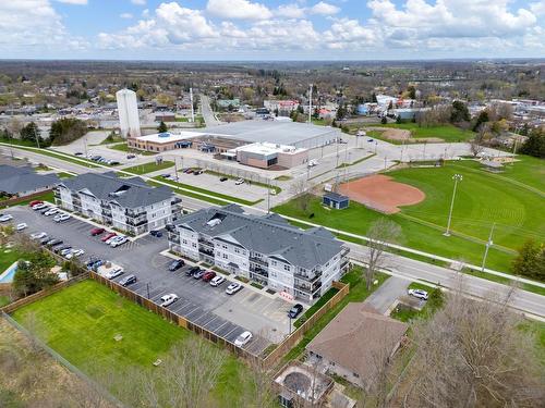 Aerial View - note the Arena, baseball diamond, play park, Library, Community Centre across the street. - 67 Haddington Street|Unit #304, Caledonia, ON - Outdoor With View