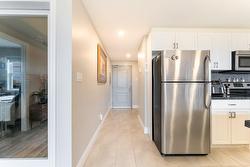 Main Entry hallway leads past laundry and bath to the central kitchen. - 