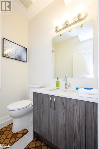 the 2 peice Powder room is just off the foyer - 1020 Ridgeline Drive, Lake Of Bays (Twp), ON - Indoor Photo Showing Bathroom