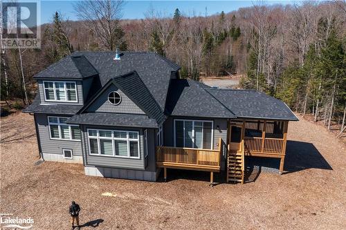Back of house showing the deck and the Muskoka room - 1020 Ridgeline Drive, Lake Of Bays (Twp), ON - Outdoor