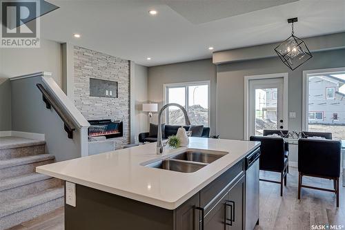 166 Kostiuk Crescent, Saskatoon, SK - Indoor Photo Showing Kitchen With Fireplace With Double Sink
