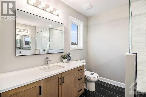 Spa-like ensuite with two vanities & tiled walk-in shower - 348 Ventoux Avenue, Ottawa, ON - Indoor Photo Showing Bathroom
