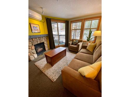 313 - 2060 Summit Drive, Panorama, BC - Indoor Photo Showing Living Room With Fireplace