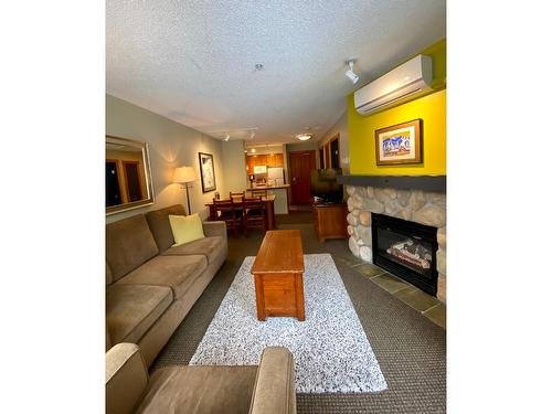 313 - 2060 Summit Drive, Panorama, BC - Indoor Photo Showing Living Room With Fireplace