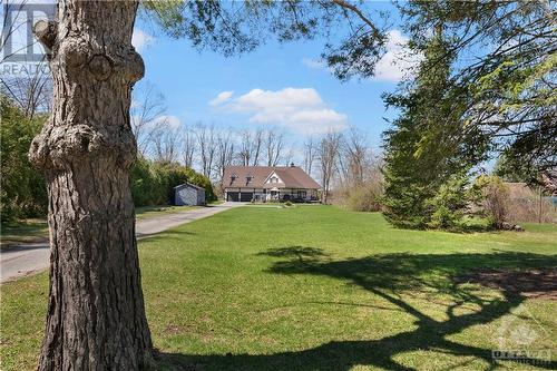 Beautiful large front lawn which has a little creek along the right hand side.  There is also a firepit on this side.  Shed is 24 x 10.  Lots of space for family games - volleyball, horseshoe toss - 3756 Mapleshore Drive, Kemptville, ON - Outdoor With View