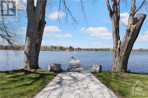 Very wide part of the river.. You get amazing sunsets here!!!  Beautiful home for entertaining!  Tie up your pontoon boat on the dock or just relax with a glass of wine at the firepit... What a fa - 3756 Mapleshore Drive, Kemptville, ON - Outdoor With Body Of Water With View