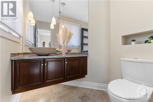 Gorgeous high end powder room situated inside the front door.  High end fixtures including stone basin and floating vanity. - 3756 Mapleshore Drive, Kemptville, ON - Indoor Photo Showing Bathroom