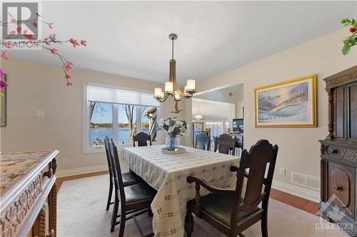Beautiful dining room situated behind the kitchen and overlooks the water.  There is a staircase in the left hand side that goes upstairs to the guest and children's bedrooms. - 3756 Mapleshore Drive, Kemptville, ON - Indoor Photo Showing Dining Room