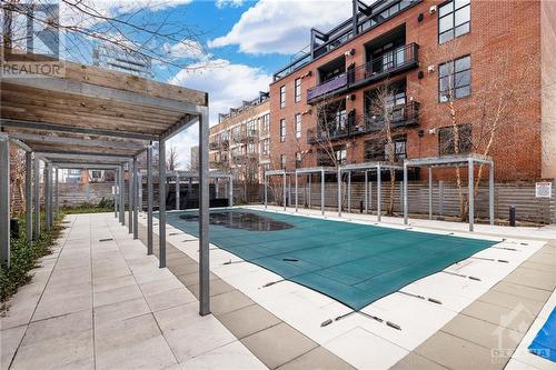 Imagine august, when the cabanas have the furniture set up and hanging out here with friends. - 340 Mcleod Street Unit#105, Ottawa, ON - Outdoor With In Ground Pool