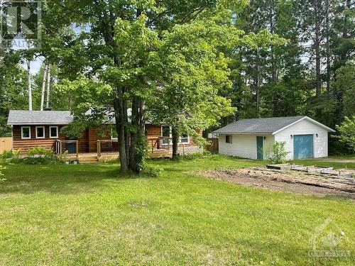 Upgrades include windows, roof, insulation, decks, plumbing  and bathroom just to name a few. The garage could have a double door at 24x20 feet, and behind that is a shipping container. - 48 Sunrise Road, Killaloe, ON - Outdoor