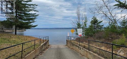 No loose gravel and ruts to contend with, this is a really clean paved launch with parking just across the road - 48 Sunrise Road, Killaloe, ON - Outdoor With Body Of Water With View