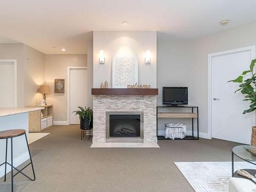 205-1335 Bear Mountain Pkwy, Langford, BC - Indoor Photo Showing Living Room With Fireplace