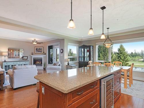 334-3666 Royal Vista Way, Courtenay, BC - Indoor Photo Showing Kitchen With Fireplace