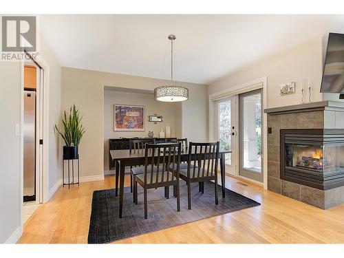 3936 Gallaghers Parkway, Kelowna, BC - Indoor Photo Showing Dining Room With Fireplace