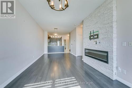 106 - 75 Eglinton Avenue W, Mississauga, ON - Indoor Photo Showing Living Room With Fireplace