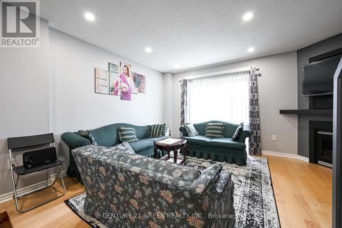 22 - 4950 Rathkeale Road, Mississauga, ON - Indoor Photo Showing Living Room With Fireplace