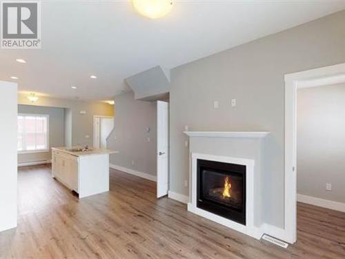 1504 11703 102 Street, Fort St. John, BC - Indoor Photo Showing Living Room With Fireplace
