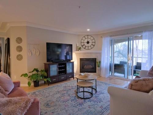 306-1966 Enterprise Way, Kelowna, BC - Indoor Photo Showing Living Room With Fireplace
