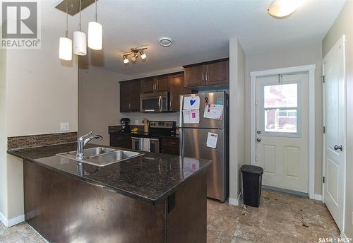 501 3440 Avonhurst Drive, Regina, SK - Indoor Photo Showing Kitchen With Double Sink