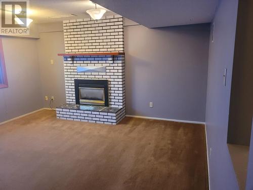 27 Mcintyre Drive, Mackenzie, BC - Indoor Photo Showing Living Room With Fireplace