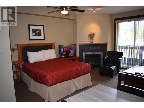 2064 Summit  Drive Unit# 110, Panorama, BC - Indoor Photo Showing Bedroom With Fireplace