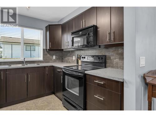 325 Mcintosh Road Unit# 1103, Kelowna, BC - Indoor Photo Showing Kitchen With Double Sink
