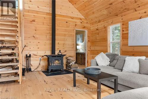1814 Riding Ranch Road, South River, ON - Indoor Photo Showing Living Room With Fireplace