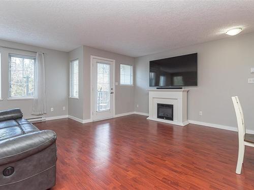209-2685 Deville Rd, Langford, BC - Indoor Photo Showing Living Room With Fireplace