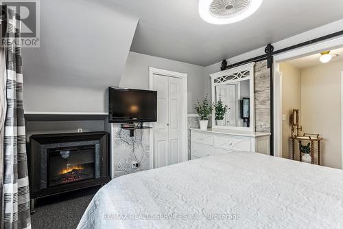 15 Avonmore Street, Brampton, ON - Indoor Photo Showing Bedroom With Fireplace
