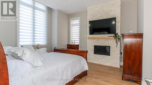 1889 Simcoe Boulevard, Innisfil, ON - Indoor Photo Showing Bedroom With Fireplace