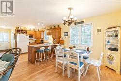 Lots of kitchen cabinets and counter space with peninsula for extra dining. - 