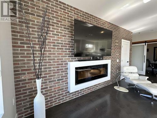 202 1694 7Th Avenue, Prince George, BC - Indoor Photo Showing Living Room With Fireplace