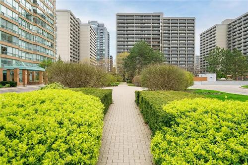 Meticulously maintained gardens throughout the property - 1270 Maple Crossing Boulevard|Unit #204, Burlington, ON - Outdoor With Facade