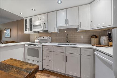 Updated, functional kitchen with quartz countertops - 1270 Maple Crossing Boulevard|Unit #204, Burlington, ON - Indoor Photo Showing Kitchen With Double Sink