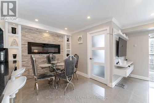 702 - 265 Enfield Place, Mississauga, ON - Indoor Photo Showing Dining Room With Fireplace