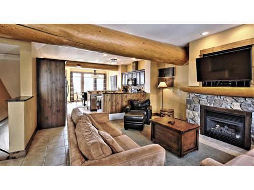 O3 A - 1351 Gerry Sorensen Way, Kimberley, BC - Indoor Photo Showing Living Room With Fireplace