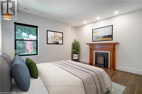 3 - 130 Windsor Crescent, London, ON - Indoor Photo Showing Bedroom With Fireplace
