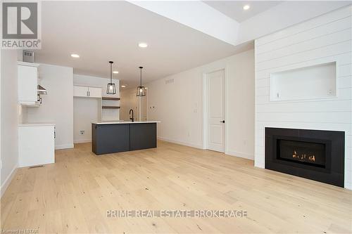 1 - 110 Coastal Crescent, Lambton Shores (Grand Bend), ON - Indoor Photo Showing Living Room With Fireplace