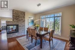 Dining area with view of Rideau Canal and fireplace - 