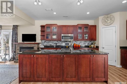 1 211 20Th Street W, Prince Albert, SK - Indoor Photo Showing Kitchen With Fireplace With Double Sink