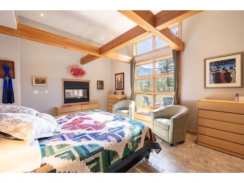 4 - 2400 Kootenay Rd No 3 Road, Invermere, BC - Indoor Photo Showing Bedroom With Fireplace