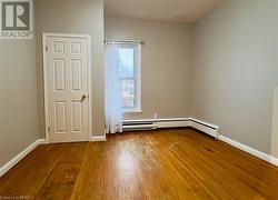 Unit 3 Bedroom 1 with original hardwood floors - 