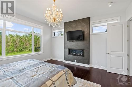 711 Ballycastle Crescent, Ottawa, ON - Indoor Photo Showing Bedroom With Fireplace