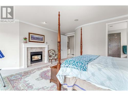 2200 Dewdney Road, Kelowna, BC - Indoor Photo Showing Bedroom With Fireplace
