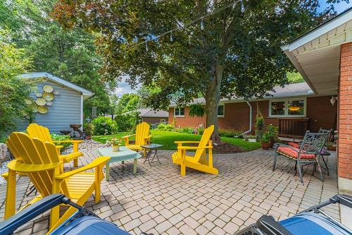 Lovely interlock pavers define the entertaining areas of the rear yard. - 28 Sunset Drive, Simcoe, ON - Outdoor With Deck Patio Veranda With Exterior