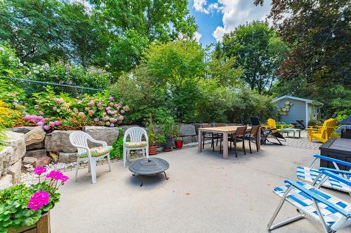 Patio area features waterfall , firepit area and dining/fun area! - 28 Sunset Drive, Simcoe, ON - Outdoor With Deck Patio Veranda